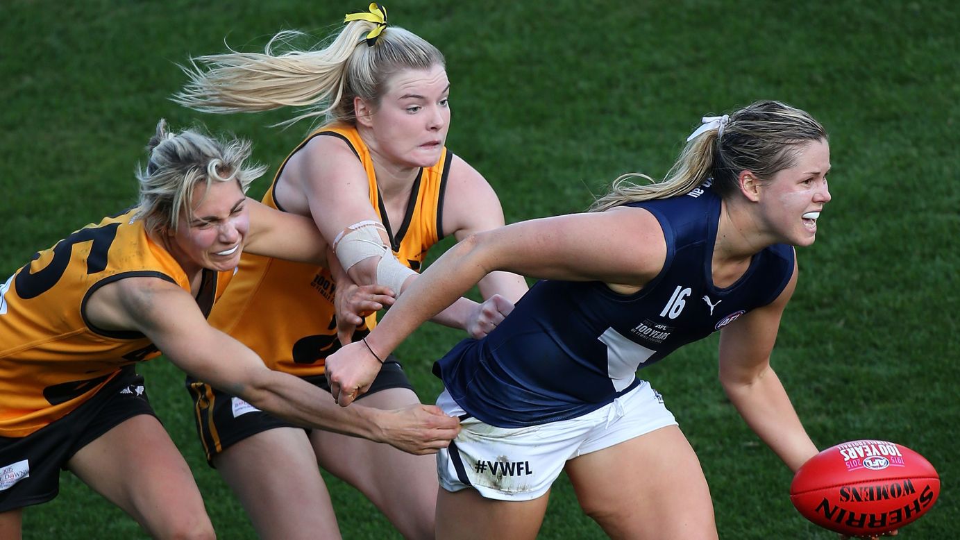 Victoria's Katie Brennan is tackled by two players from Western Australia during an Australian rules football match on Friday, June 5. 
