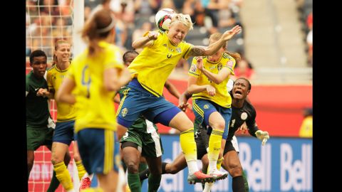 Sweden's Nilla Fischer heads the ball for her team's first goal.