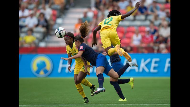 Cameroon's Jeannette Yango, left, and Claudine Meffometou Tcheno, right, collide with Ecuador's Giannina Lattanzio.