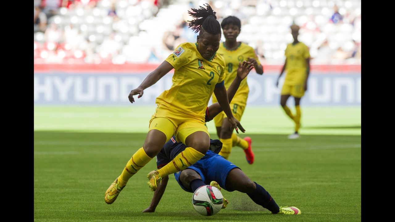 Christine Manie of Cameroon jumps to avoid the tackle of Monica Quinteros.