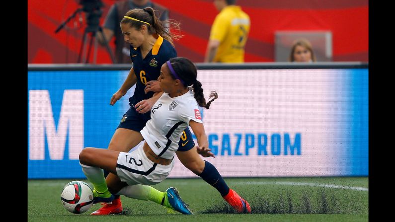 U.S. forward Sydney Leroux slides into Australia's Servet Uzunlar.