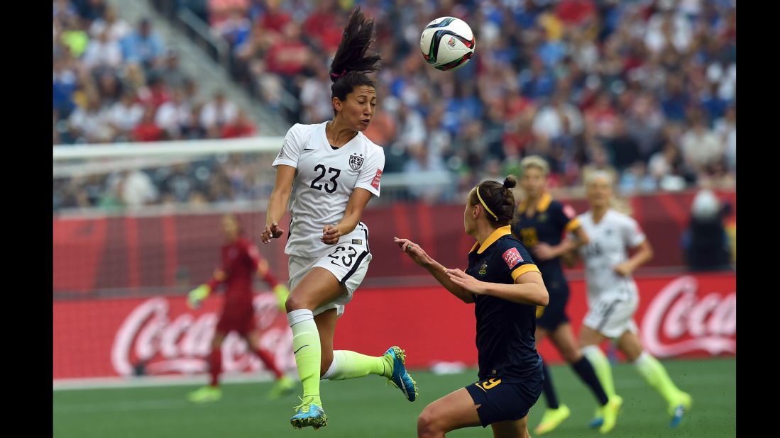 U.S. forward Christen Press heads the ball.