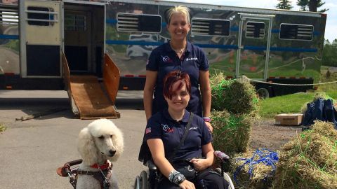 Sydney Collier with mom Anna and Journey. The dog travels transatlantic in the cabin alongside Sydney to major events.