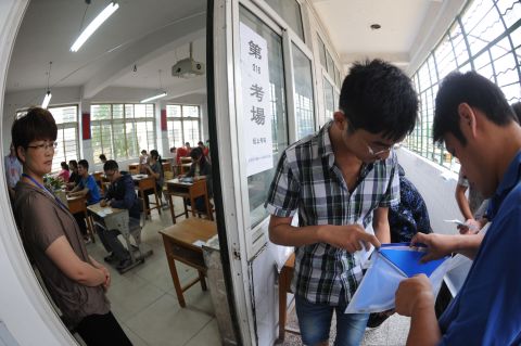 A Chinese student gets his belongings searched before he enters the room to take the tough college entrance exams or Gaokao, in east China's Anhui province on June 7, 2012. 