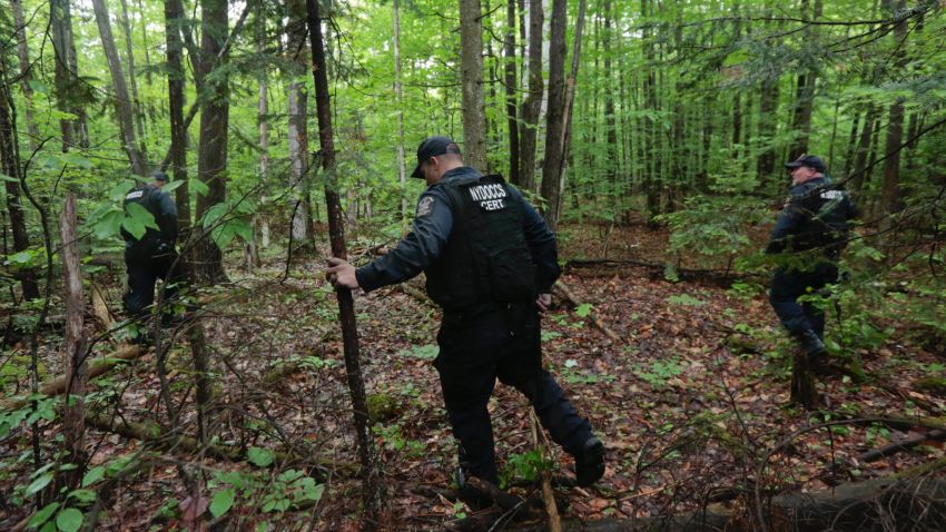 Members of the New York State Department of Corrections and Community Supervision emergency response team search a wooded area for two prisoners who escaped from the Clinton Correctional Facility on Monday, June 8, 2015, in Dannemora, N.Y. The two murderers who escaped from the prison by cutting through steel walls and pipes remain on the loose Monday as authorities investigate how the inmates obtained the power tools used in the breakout. (AP Photo/Mike Groll)