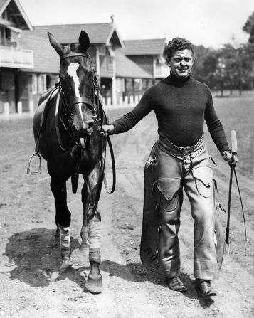 An American "stick and ball" man working for a British polo player wears a pair of cowboy's chaps as he leads out a pony at Hurlingham in 1936 -- a reminder of the long-standing connection between horses and a classic American style.