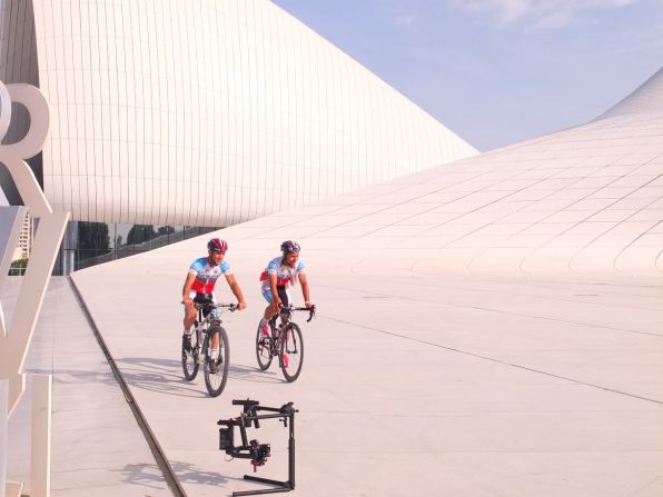 Ismailov and colleague Tural Isgandarov cycle past the cultural center.