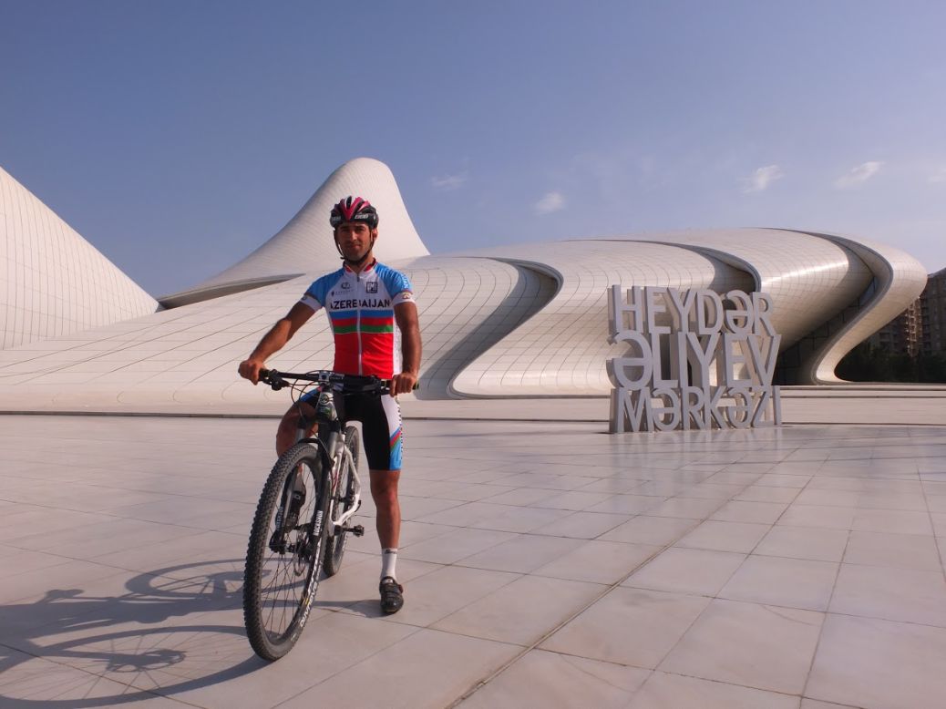 Mountain biker Aqshin Ismailov, who will be the first athlete from Azerbaijan to take part in competitive action at the European Games, poses by the dramatic and futuristic Heydar Aliyev Cultural Centre in Baku.