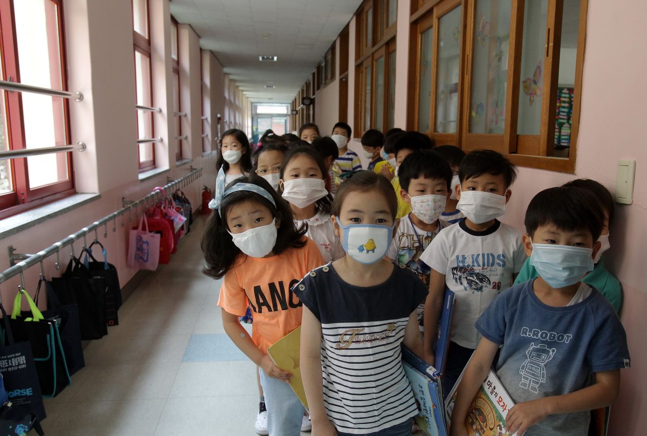 Elementary school students wear masks as a precaution against the MERS virus as they wait for a lesson to start at Midong Elementary School in Seoul, South Korea.