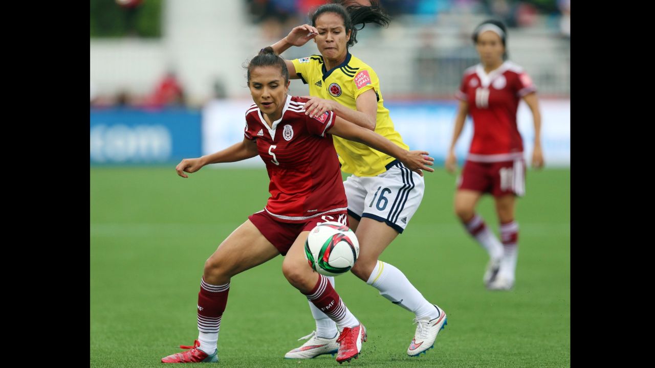 Mexico's Valerie Miranda, left, and Colombia's Lady Andrade battle for the ball during a match June 9 in Moncton. The match ended in a 1-1 draw.