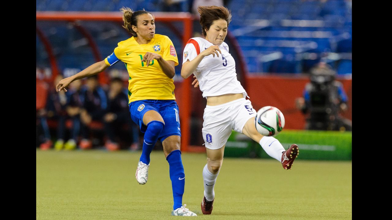 South Korea's Kim Do-yeon tries to move the ball past Marta. 