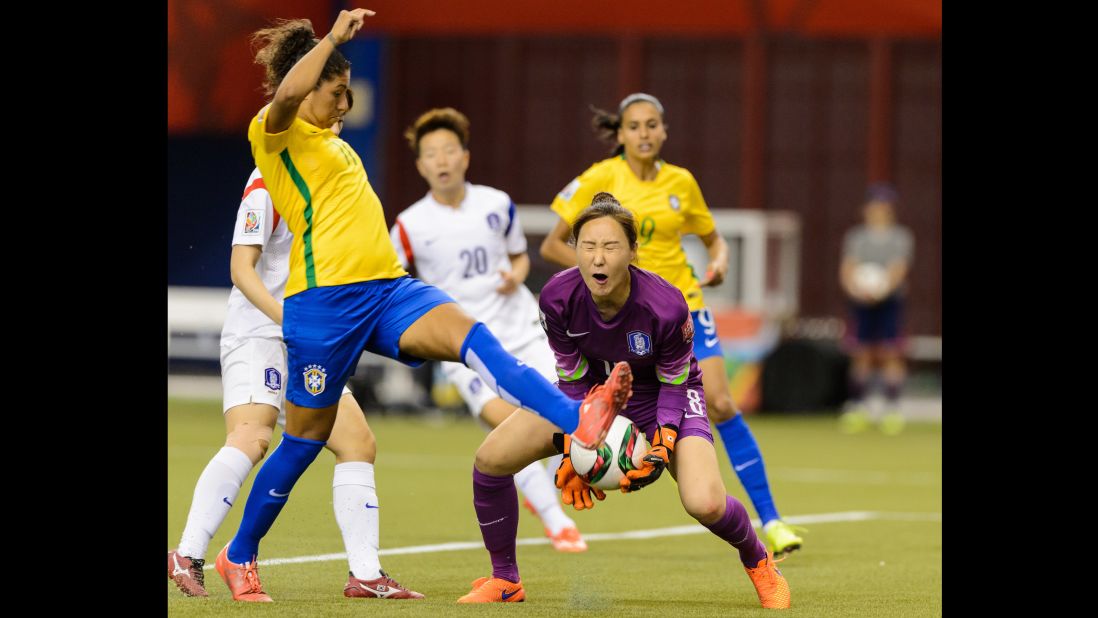 South Korean hoalkeeper Kim Jung-mi makes a save near Brazil's Cristiane. 