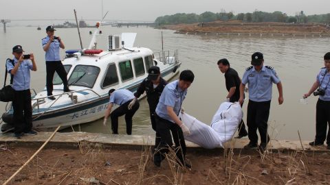 Police carry a body to the shore of the Yangtze River in Nanjing, China, on Tuesday, June 9. The Eastern Star cruise ship sank late Monday, June 1, in stormy weather, with more than 450 passengers and crew on board.