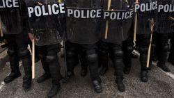 Riot police hold their position during a protest in Baltimore, Maryland, on April 25, 2015, against the death of Freddie Gray while in police custody. Protesters targeted businesses and smashed police cars in downtown Baltimore on Saturday as the biggest demonstration yet over the death of Gray in police custody turned violent.  AFP PHOTO / ANDREW CABALLERO-REYNOLDS        (Photo credit should read Andrew Caballero-Reynolds/AFP/Getty Images)