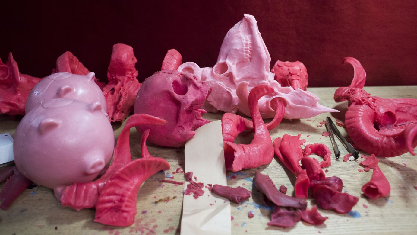 A collection of pink skulls, horns and other decorative fragments in various states.