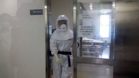 A health care worker in a full hazmat suit exits a patient's room at the Seoul Medical Center where eight people with MERS is being treated. 