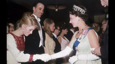 Lee, second from left, stands by as Queen Elizabeth II greets French actress Catherine Deneuve in 1966. Also present, from left, are Ursula Andress, Woody Allen and Raquel Welch. Lee was named a knight of the British Empire in 2009.