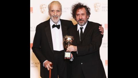 Director Tim Burton presents Lee with the Academy Fellowship, a lifetime achievement award, at the British Academy Film Awards in 2011.