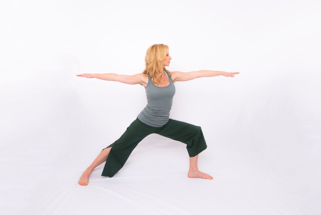 Step your right leg back, as though you are coming into a lunge position, but drop the right heel and point the toes out to almost 90 degrees. Keep your right leg straight with your left knee bent to align above your ankle. With your shoulders aligned above your hips, reach your right arm back and left arm forward with your palms down. Look past your front hand and take five long, deep breaths. Repeat on the other side. 