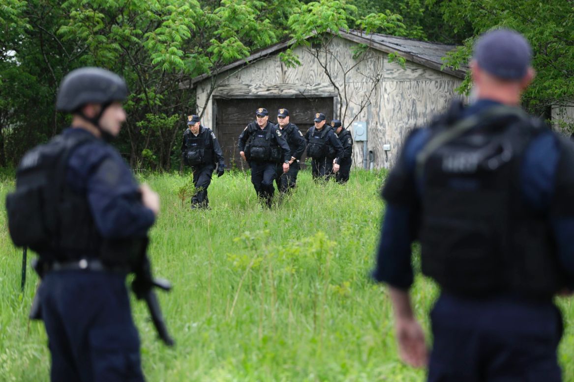 Officers continue their search in Essex, New York, on Tuesday, June 9.