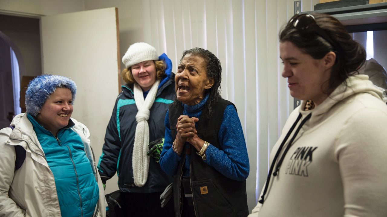 Alice Lawrence chats with Mountain View residents at her house, where she hands put food discarded by grocery stores to people in need.