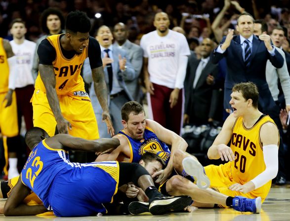 Dellavedova (center, under pile) is known for his scrappy style of play, which has drawn criticism from opponents. He is shown fighting for a loose ball in the fourth quarter during Game 3 of the 2015 NBA Finals at Quicken Loans Arena on June 9, 2015 in Cleveland, Ohio.