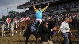 Jockey Victor Espinoza, aboard American Pharoah, celebrates after winning the 147th running of the Belmont Stakes as well as the Triple Crown, in Elmont, New York.