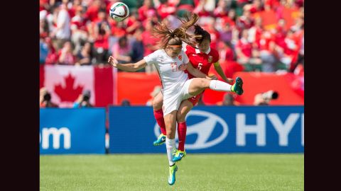 Martens, left, and China's Haiyan Wu compete for a header.