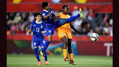 Anootsara Maijaren of Thailand, center, challenges Christine Lohoues of Ivory Coast during a Women's World Cup match in Ottawa on Thursday, June 11. Thailand won the match 3-2. 