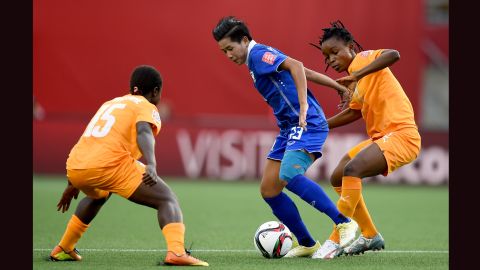 Nisa Romyen of Thailand tried to protect the ball from Lohoues, left, and Fatou Coulibaly.