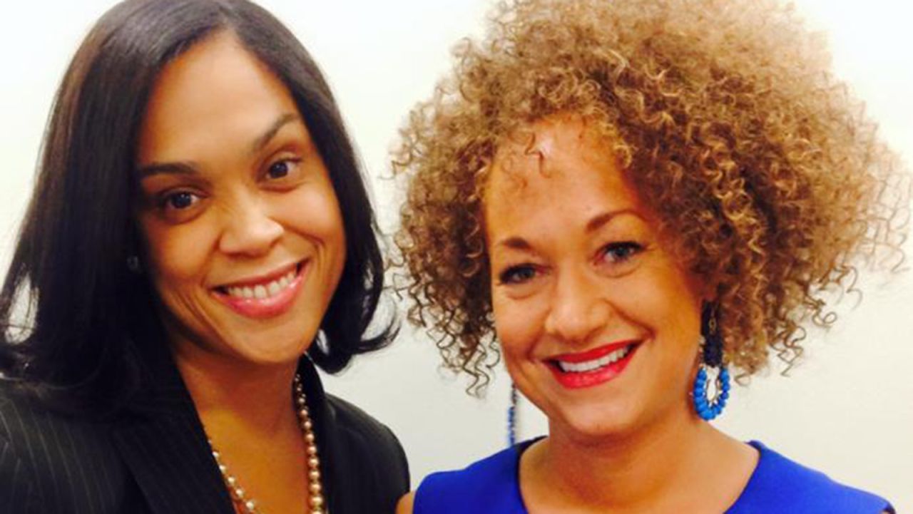 Dolezal poses for a picture with prosecutor Marilyn Mosby. Dolezal's mother said on Friday, June 12, that her daughter "has not explained to us why she is doing what she's doing and being dishonest and deceptive with her identity."