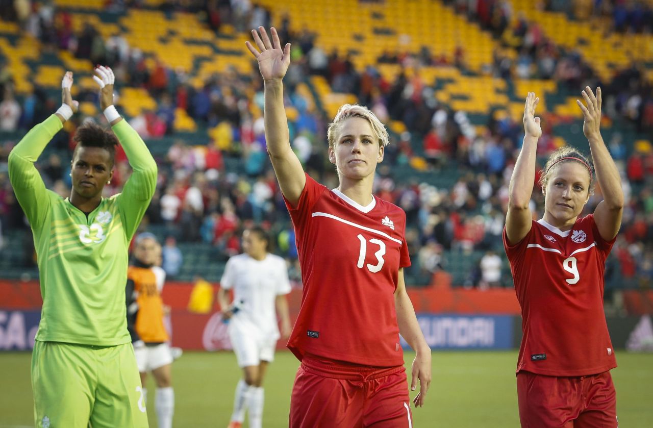 From left, Canada's Karina LeBlanc, Sophie Schmidt and Josee Belanger wave to fans in Edmonton after a 0-0 draw against New Zealand on Thursday, June 11.