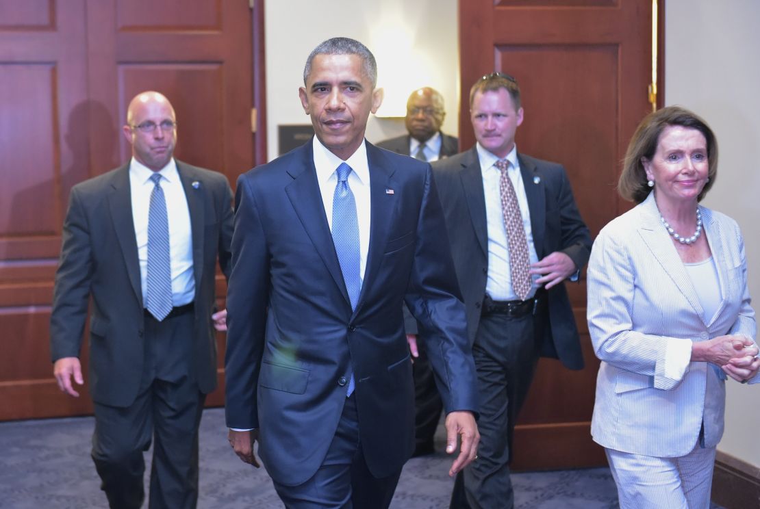 U.S. President Barack Obama and House Minority Leader Nancy Pelossi walk through a hallway after meeting on trade with House Democrats at the U.S. Capitol on June 12, 2015 in Washington, D.C. 