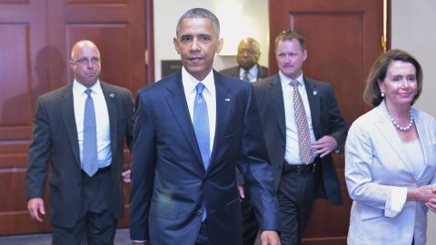 U.S. President Barack Obama and House Minority Leader Nancy Pelossi walk through a hallway after meeting on trade with House Democrats at the U.S. Capitol on June 12, 2015 in Washington, D.C.