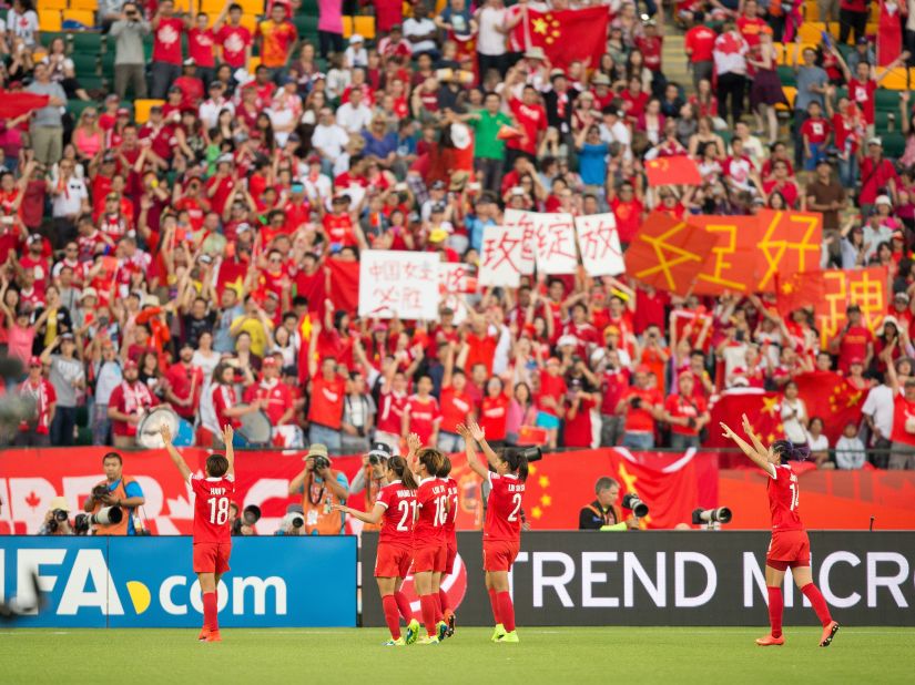 China players celebrate with supporters in Edmonton following their 1-0 win against the Netherlands on June 11.