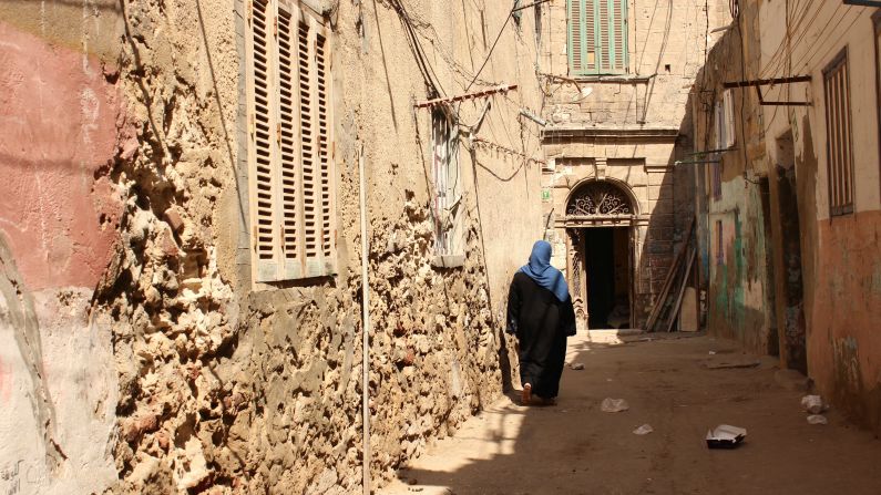 <a href="index.php?page=&url=http%3A%2F%2Fireport.cnn.com%2Fdocs%2FDOC-1248211">Nahla EINemr </a>shot this woman walking through Egyptian neighborhood Kom El Dikka. She felt that the photo represented Egypt in the architecture and traditional clothing shown. "I love this photo because of the shadows cast on the woman's dress, like she is wearing those rays," EINemr said.