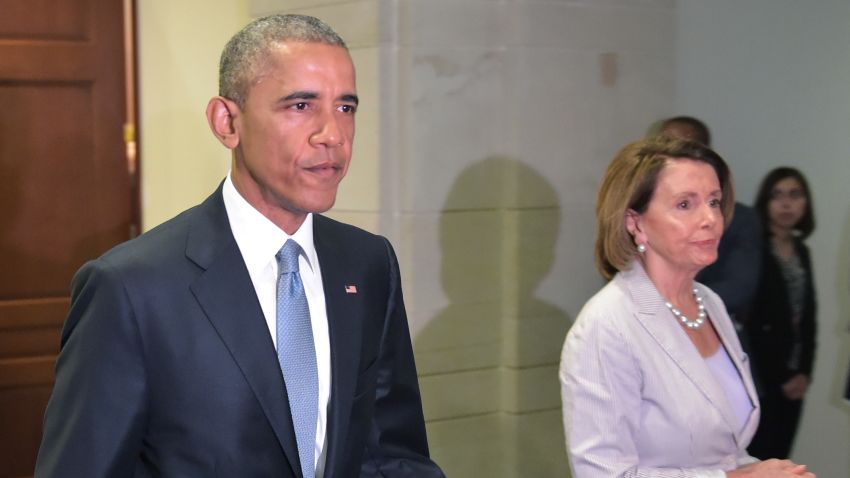 President Barack Obama and House Minority Leader Nancy Pelosi walk through a hallway after meeting with House Democrats at the U.S. Capitol on June 12, 2015 in Washington, DC.