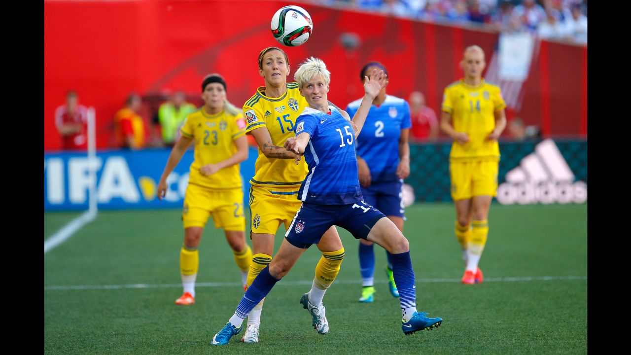 Rapinoe tries to hold off Sweden's Therese Sjogran. 
