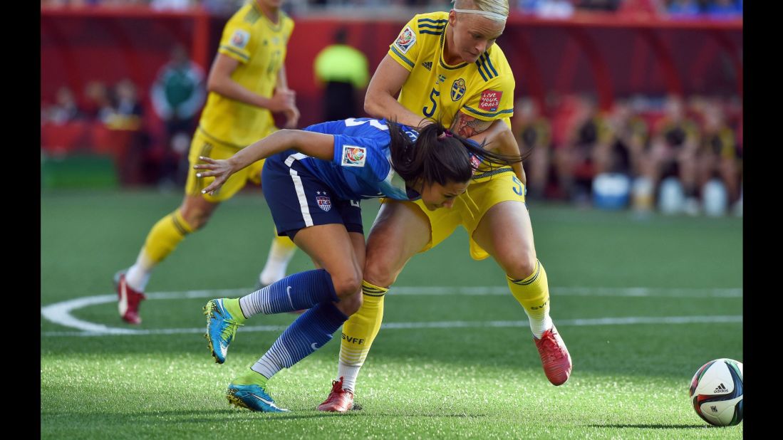 U.S. forward Christen Press, left, fights for the ball with Sweden defender Nilla Fischer. 
