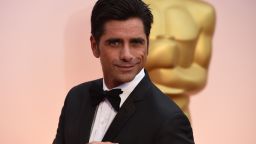 Caption:John Stamos arrives on the red carpet for the 87th Oscars February 22, 2015 in Hollywood, California. AFP PHOTO / MARK RALSTON (Photo credit should read MARK RALSTON/AFP/Getty Images)
