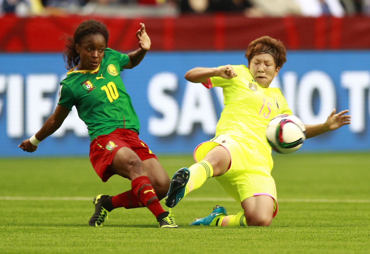 Jeannette Yango of Cameroon, left, and Yuika Sugasawa of Japan battle for a loose ball Friday, June 12, in Vancouver. Japan defeated Cameroon 2-1. 