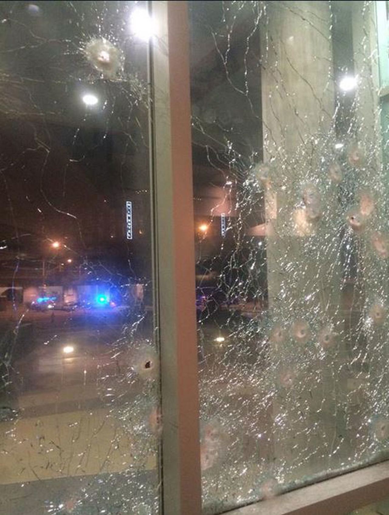 Bullet holes can be seen in the windows of the headquarters. 