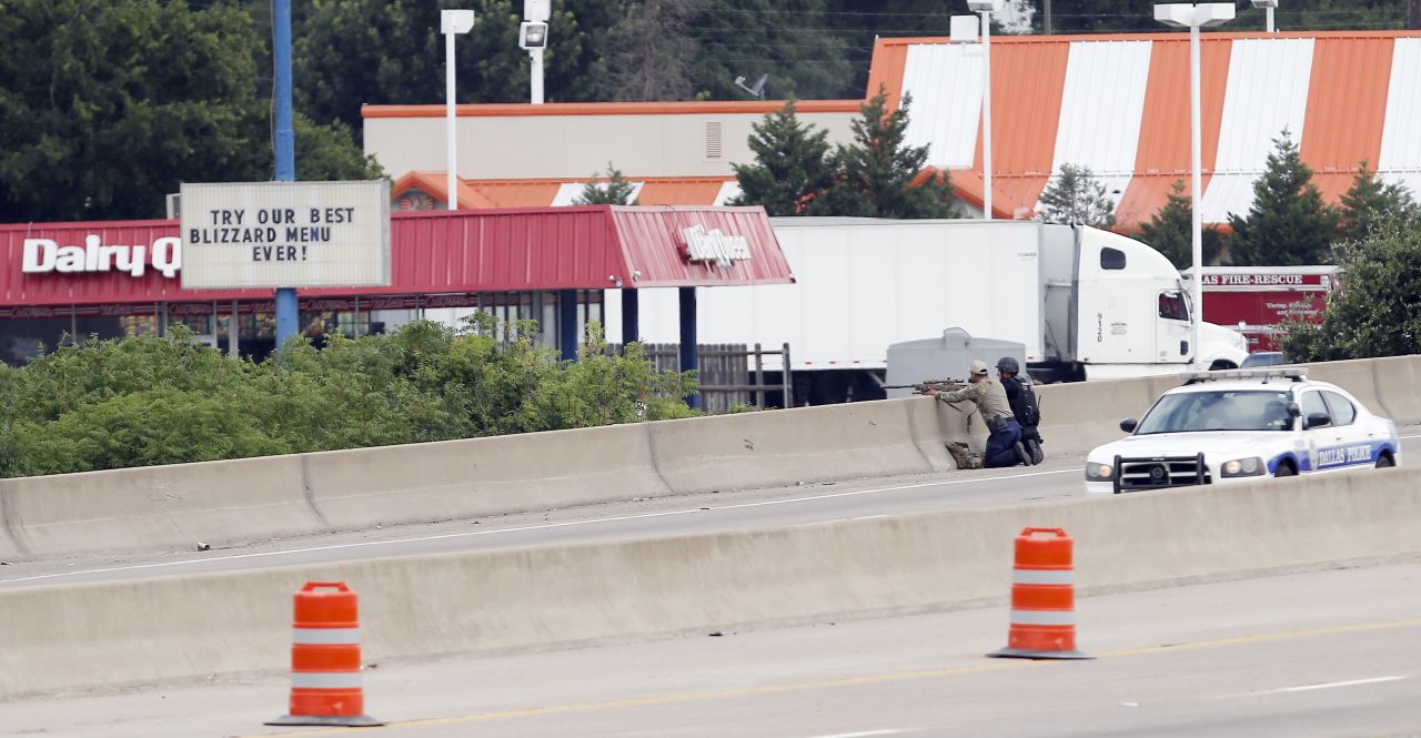 A sniper and a tactical officer take up positions on the shoulder of Interstate 45 at Dowdy Ferry Road.