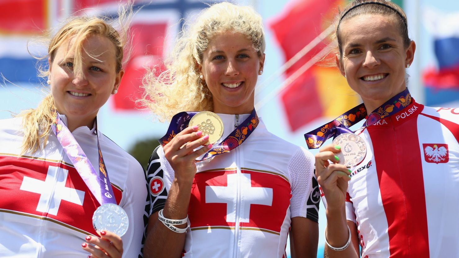 Switzerland's Jolanda Neff, the first gold medal winner at the inaugural European Games, is flanked by the other medalists in the women's mountain bike event.
