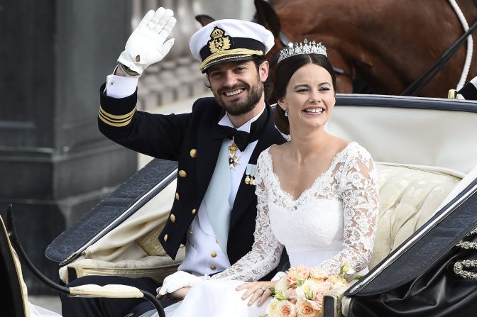 Sweden's Prince Carl Philip sits with his bride, Sofia Hellqvist, in a carriage after their wedding ceremony in Stockholm, Sweden, on Saturday, June 13. The 36-year-old prince and the 30-year-old former reality-TV star tied the knot Saturday at the Royal Palace chapel before five European queens, a Japanese princess and dozens of other blue-blooded guests.  