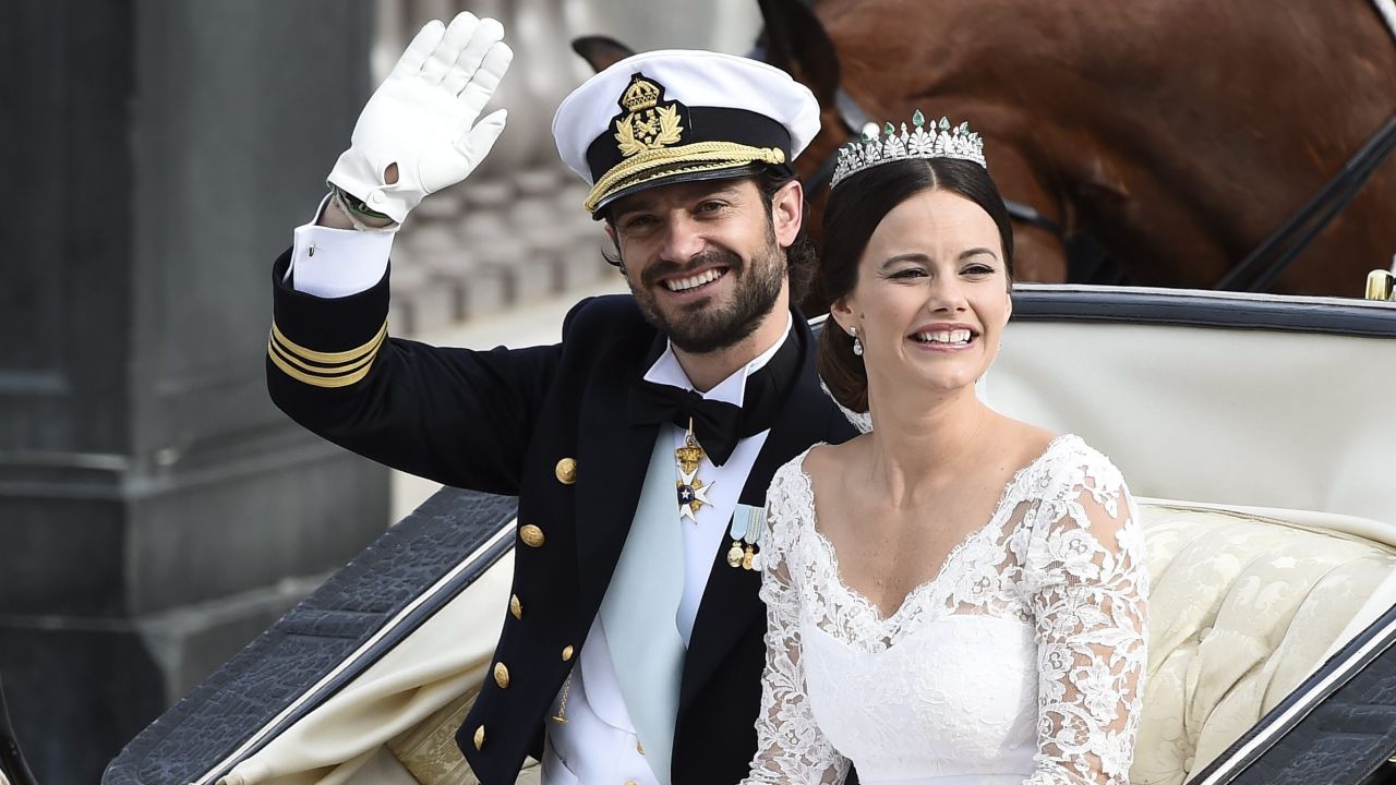 Sweden's Prince Carl Philip sits with his bride, Sofia Hellqvist in a carriage, after their wedding ceremony,  in Stockholm, Sweden, on Saturday, June 13.   Prince Carl Philip and the former reality starlet and model Sofia Hellqvist, 30, tied the knot Saturday at the Royal Palace chapel before five European queens, a Japanese princess and dozens of other blue-blooded guests.  