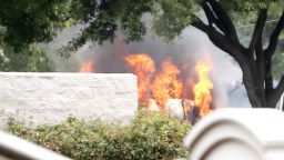 The armoured van used by a lone shooter to attack and then flee Dallas Police Headquarters catches fire outside a fast food restaurant on June 13,  in Hutchins, Texas. Authorities used controlled charges to discharge pipe bombs in the van after the shooter reportedly unleashed multiple rounds and planted explosive devices around the station before leading police on a chase that ended in a standoff in the parking lot of a fast food restaurant.