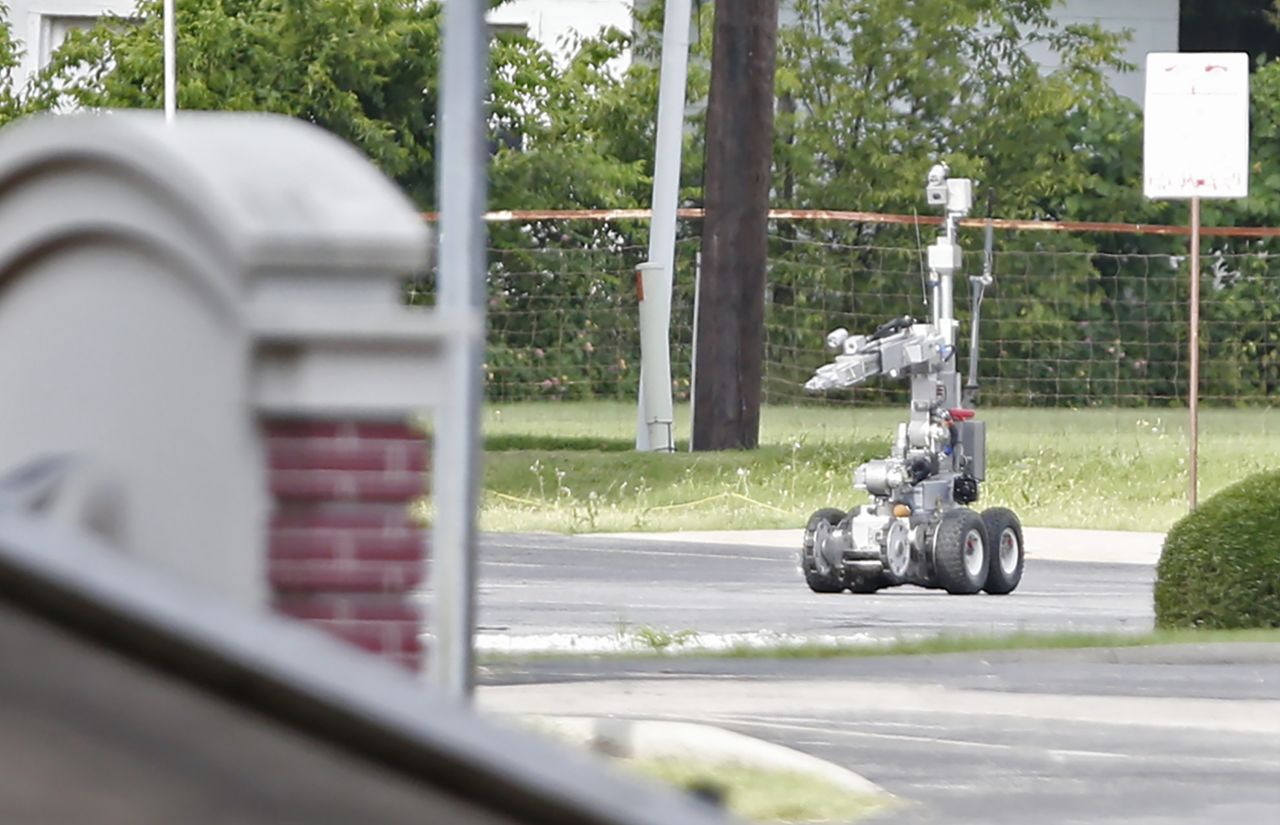  Police use a robot to gain access to the suspect's van, which authorities believed was rigged with explosives.