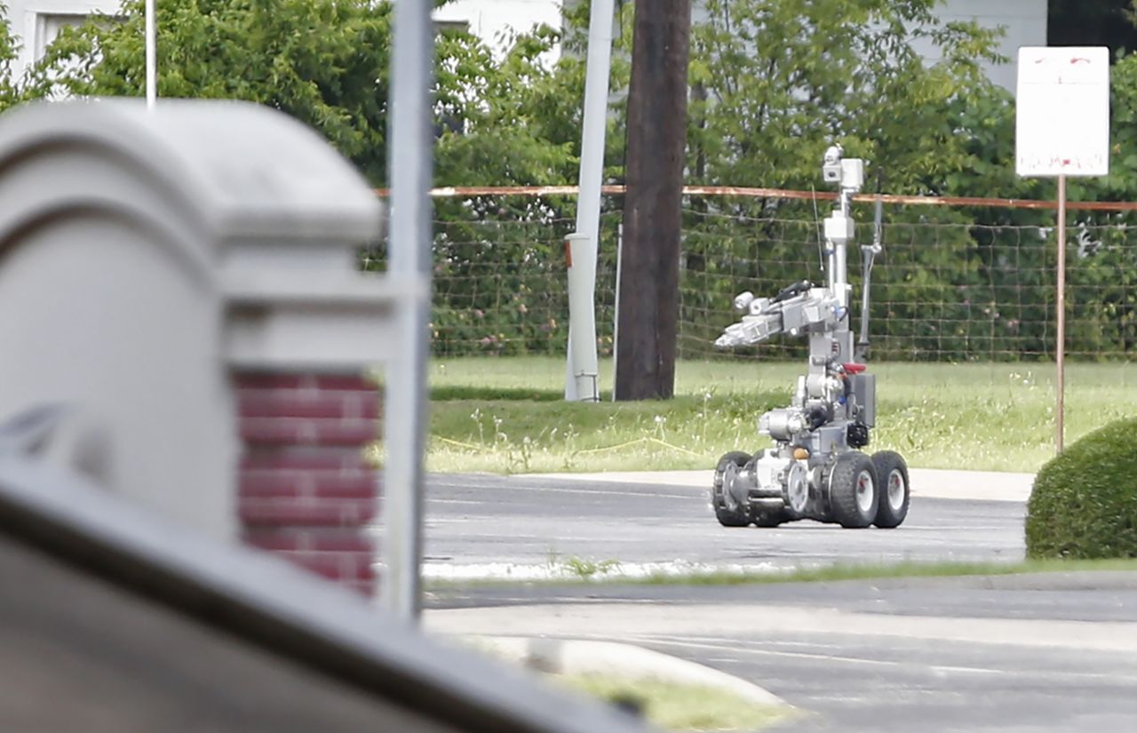 Police use a robot to gain access to the suspect's van, which authorities believed was rigged with explosives.