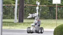 Police use a robot to gain access to the suspects armoured van, which authorities believed was rigged with explosives.